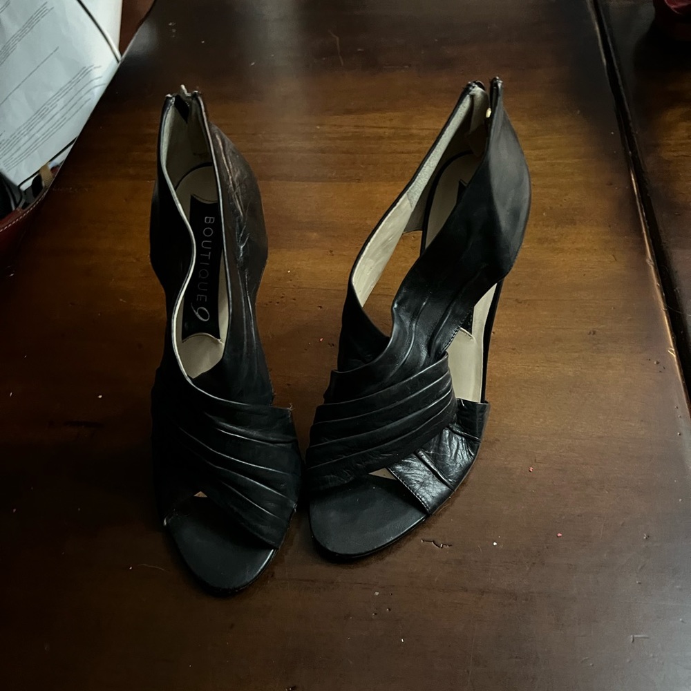 Black leather open toe heels.